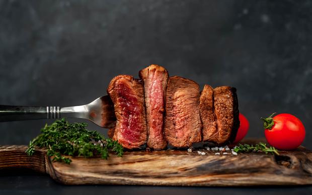 Four,Steaks,On,Fork,On,A,Cutting,Board,On,A